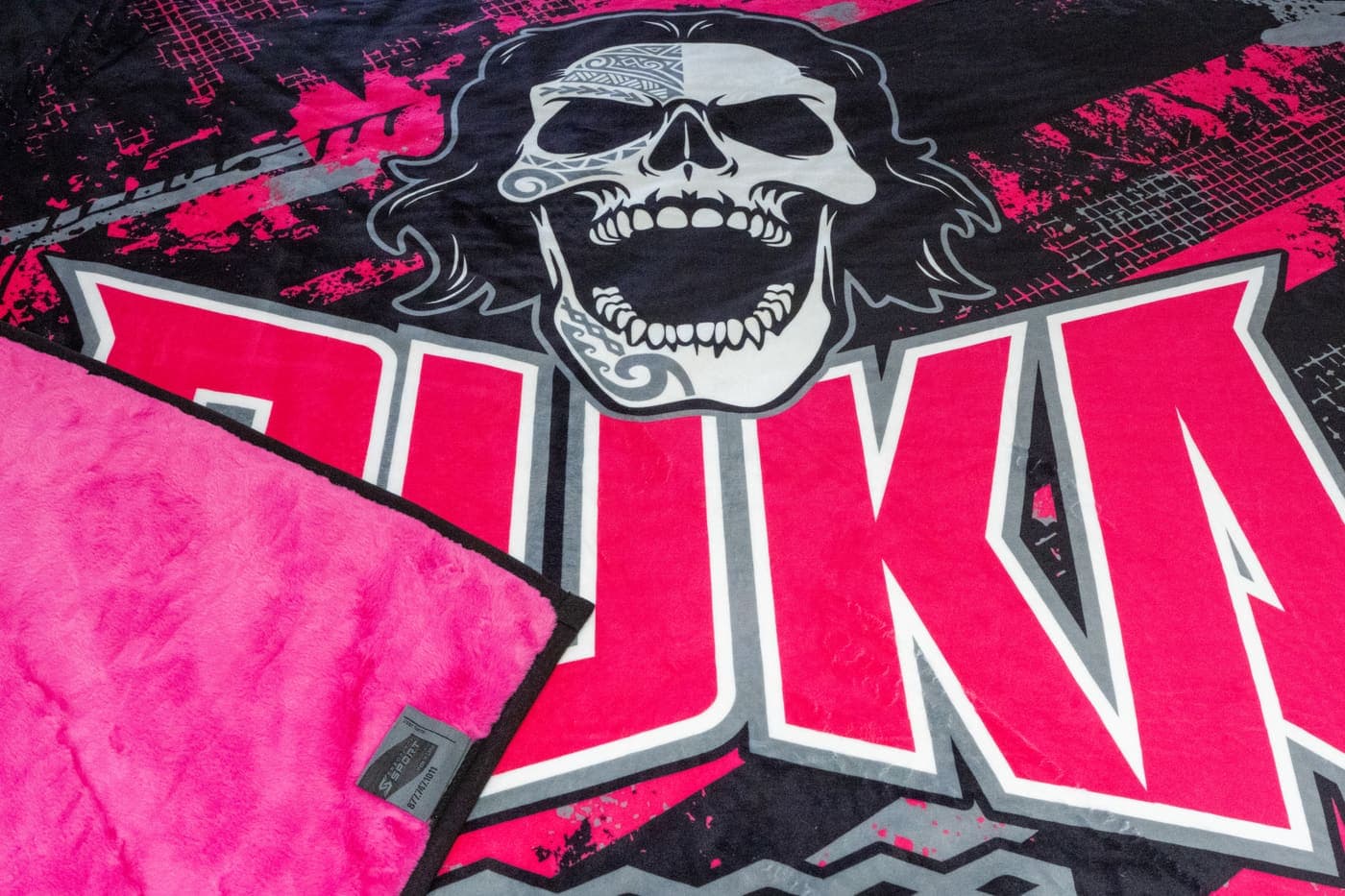 Close-up of a photo-realistic mascot print on a pink-backed Swanky NubaySoft blanket